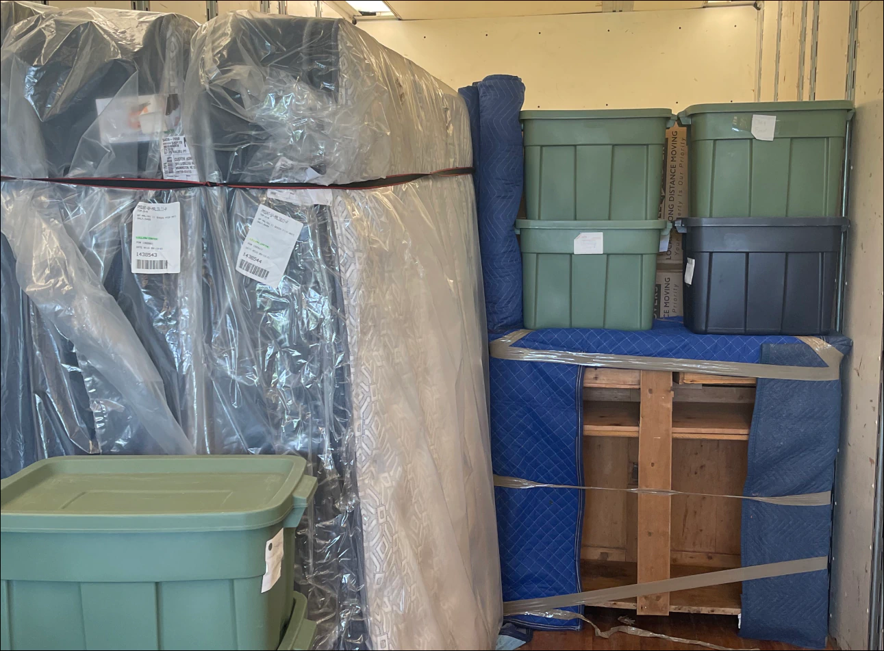 a garage full of moving boxes and matresses